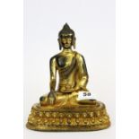 A Tibetan gilt bronze figure of the seated Buddha, H. 20cm.