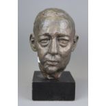 A bronze bust of a gentleman on a black painted wooden plinth, initialled L.E, H. 31cm.