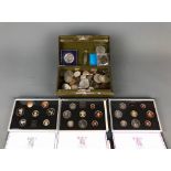 A cased UK three proof coin collection for years 1983, 84 and 85, together with a box of UK and