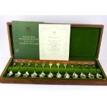 A cased set of twelve 24ct gold and hallmarked silver flower spoons issued by 'The Royal