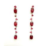 A pair of 925 silver drop earrings set with oval cut rubies, L. 5cm.