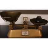 Two vintage cast iron and brass shop scales with wooden cases.