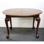 A Victorian wind out extending dining table with ball and claw foot, closed Dia. 110cm open Dia.