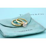 A Tiffany & Co 18ct yellow gold and platinum 1.03ct brilliant cut diamond set ring and matching