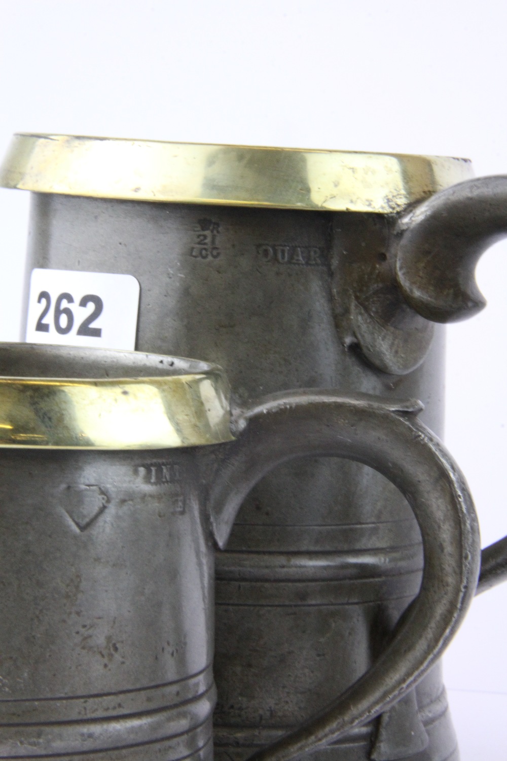 A set of four pewter and brass rimmed graduated tankards, tallest H. 15.5cm. - Image 3 of 3
