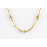 A 9ct yellow gold (stamped 375) bead necklace, L. 44cm.