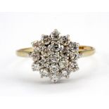 A 9ct yellow gold stone set cluster ring, (V).