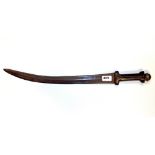 An 18th/19th Century Eastern sword with curved blade and carved hardwood hilt, L. 60cm.