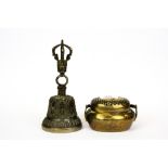 A Tibetan bell together with a Chinese hand warmer, tallest H. 18cm.