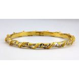 A 22ct yellow and white gold bangle, Dia. 5.8cm.