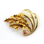 An 18ct yellow gold (stamped 750) ruby set brooch, L. 4.5cm.