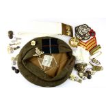 A First World War Scottish army cap with belt and various badges.