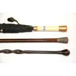 An Edwardian 15ct gold and ivory mounted umbrella with a silver mounted walking stick and a