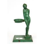 A 1920's Art Deco green painted metal figural tea light holder, H. 21cm.