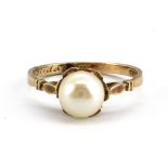 An Edwardian 9ct yellow gold pearl set ring, inscribed "Solidarity" inside the shank, (N).