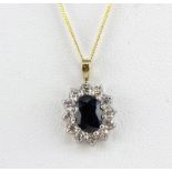 A 9ct yellow gold pendant and chain, pendant set with a sapphire surrounded by white stones, pendant