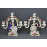A pair of Dresden three branch candelabra decorated with dancing couples and flowers (one dancer has