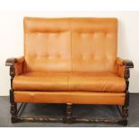 A 1930's re-upholstered oak two seater settee, H. 90cm, W. 117cm.