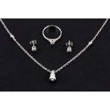 An 18ct white gold (stamped 75) suite of jewellery comprising ring, stud earrings and pendant and
