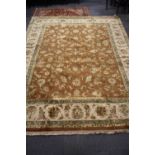 An Indian Amber wool and silk hand knotted rug, size 305 x 241cm.