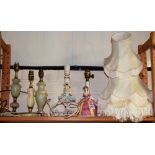 Three onyx mounted table lamps, two porcelain figural table lamps and three lamp shades, tallest