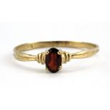 A 9ct yellow gold garnet set ring, (V.5).