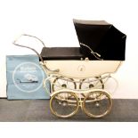 A vintage white enamelled pram with a boxed pram canopy, H. 110cm W. 120cm.