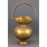 A 19th Century engraved Indian brass spittoon, H. 52cm.