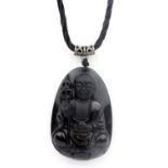 A fine carved obsidian amulet of the Buddha. L.5cms on a silk cord.