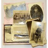 A box of First World War and other photographs and postcards.