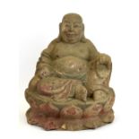 A Chinese carved and painted figure of the happy Buddha, H. 25cm.