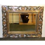A large ornately framed mirror, size 110 x 91cm.