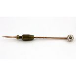 A boxed antique rose metal (tested 9ct gold) stick pin set with a brilliant cut diamond, L. 6cm.