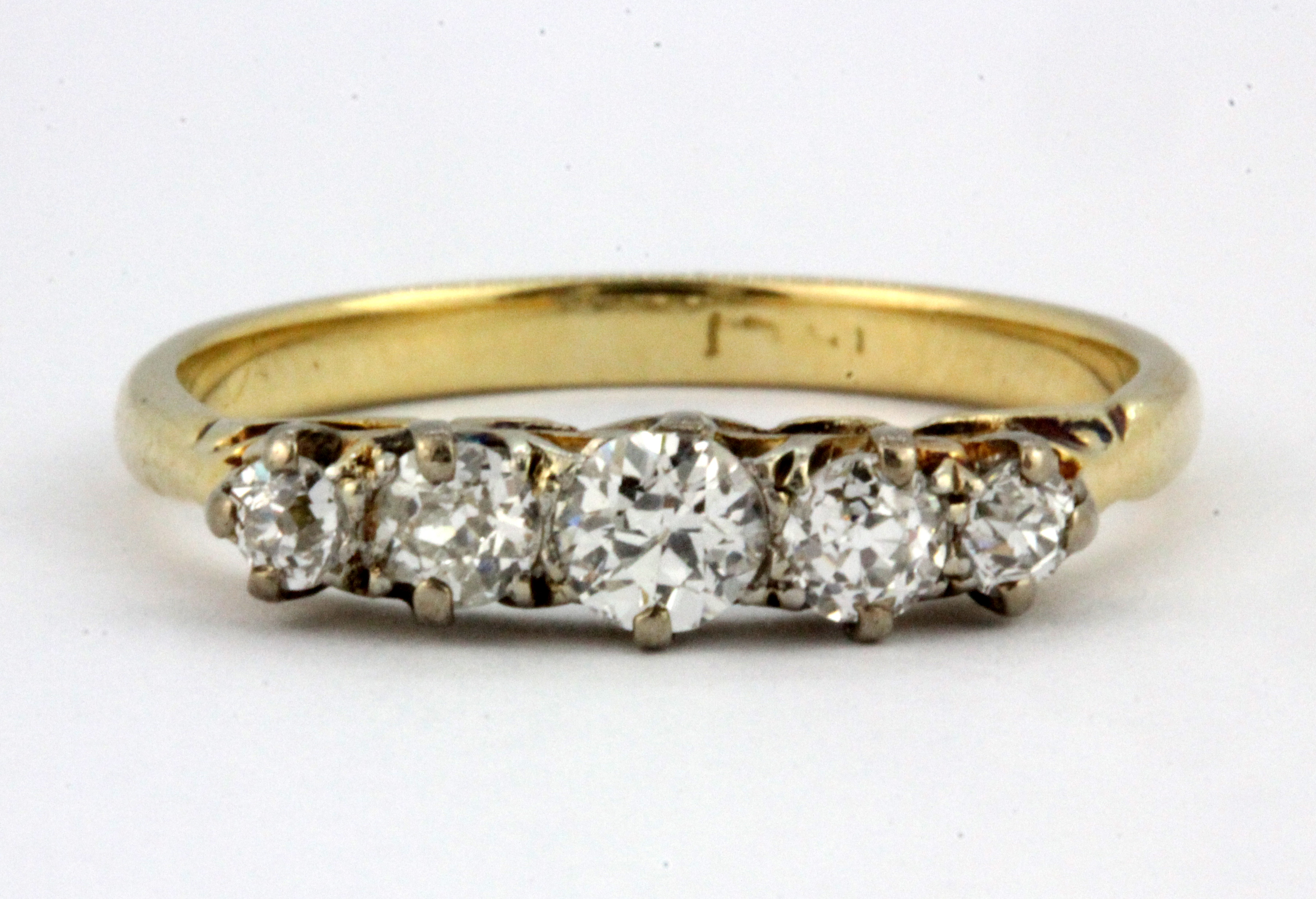 A boxed 18ct yellow gold (worn stamp 18ct) graduated brilliant cut diamond set ring, (P.5).