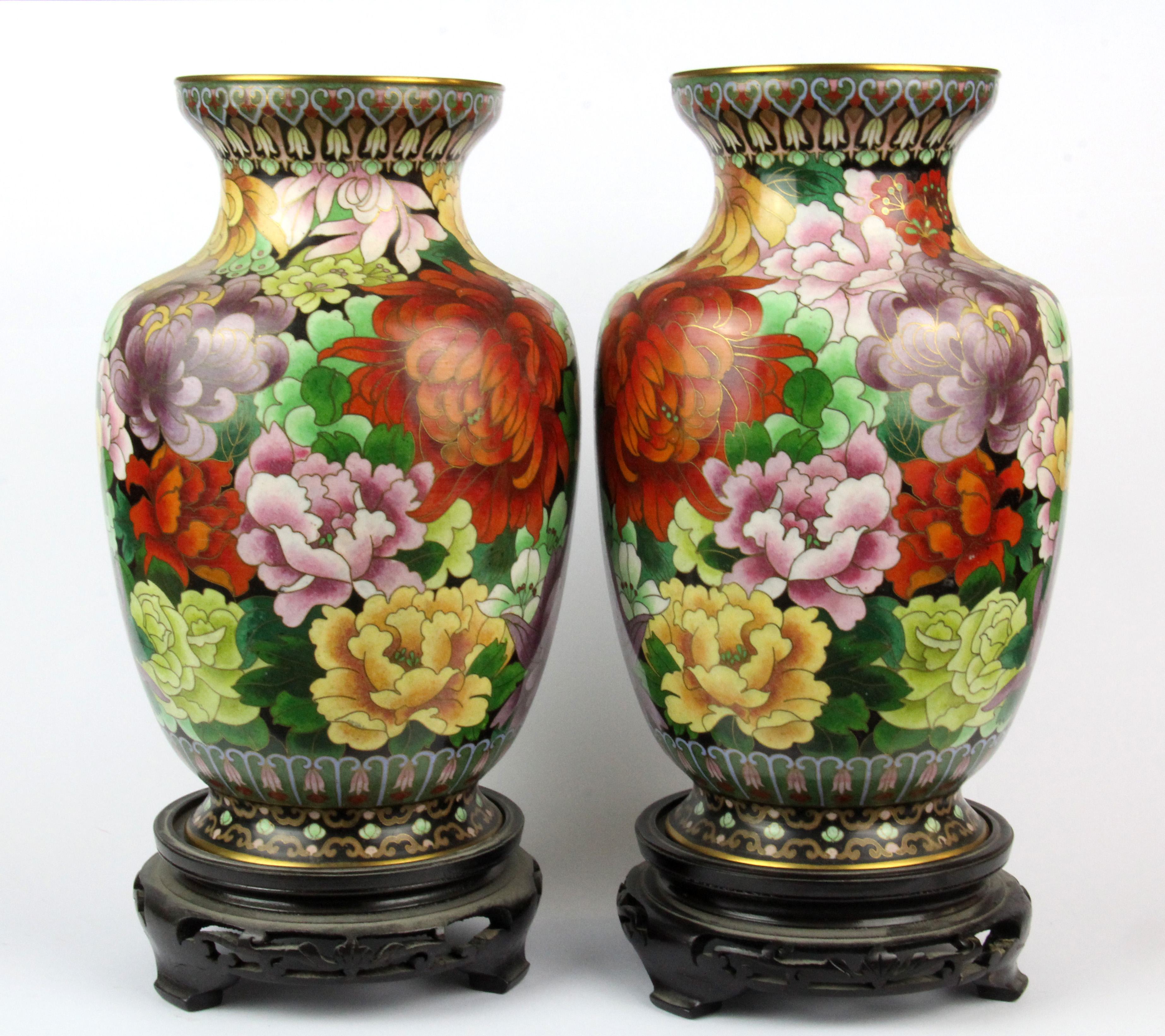 A pair of Chinese cloisonne vases on carved wooden stands, H. 30cm.