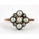 An boxed Edwardian rose metal (tested 9ct gold) ring set with old cut diamonds and pearls, (N).