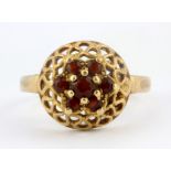 A 9ct yellow gold (stamped 9ct) garnet set cluster ring, (K.5).