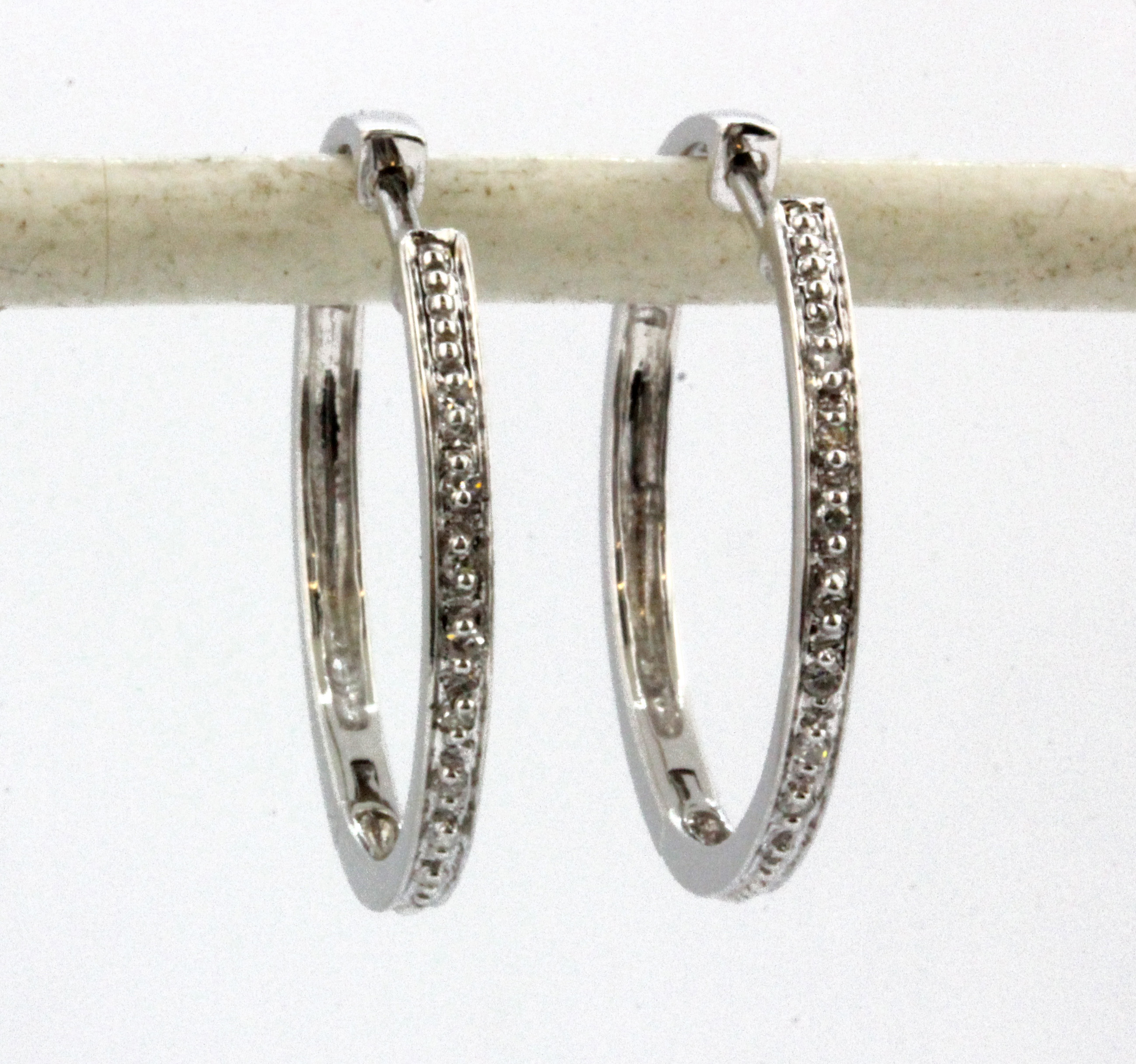 A pair of 14ct white gold diamond set hoop earrings, Dia. 2cm.