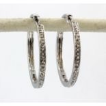 A pair of 14ct white gold diamond set hoop earrings, Dia. 2cm.