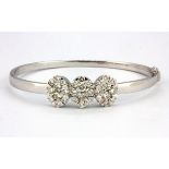 An 18ct white gold (stamped 750) bangle set with approx. 3ct of brilliant cut diamonds, L. 5.5cm.