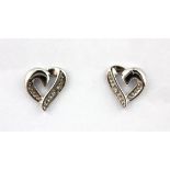 A pair of 9ct white gold diamond set heart shaped earrings, L. 0.7cm.