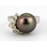 A white metal (tested 18ct gold) ring set with a South Sea black pearl and diamonds, (N).