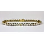 An 18ct yellow gold (stamped 750) brilliant cut diamond set tennis bracelet, approx. 4.5ct