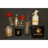 A group of vintage soda syphons and bar items.