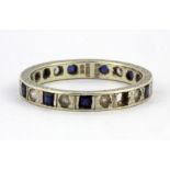 A 9ct white gold stone set full eternity ring, (one stone missing), (N.5).