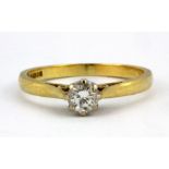 An 18ct yellow gold solitaire ring set with a brilliant cut diamond, (L.5).