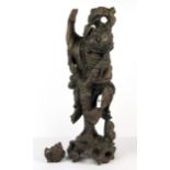 A large carved Chinese hardwood figure of a lucky character holding a teapot, H. 49cm.