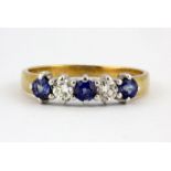 An 18ct yellow gold sapphire and diamond set half eternity ring, (M).