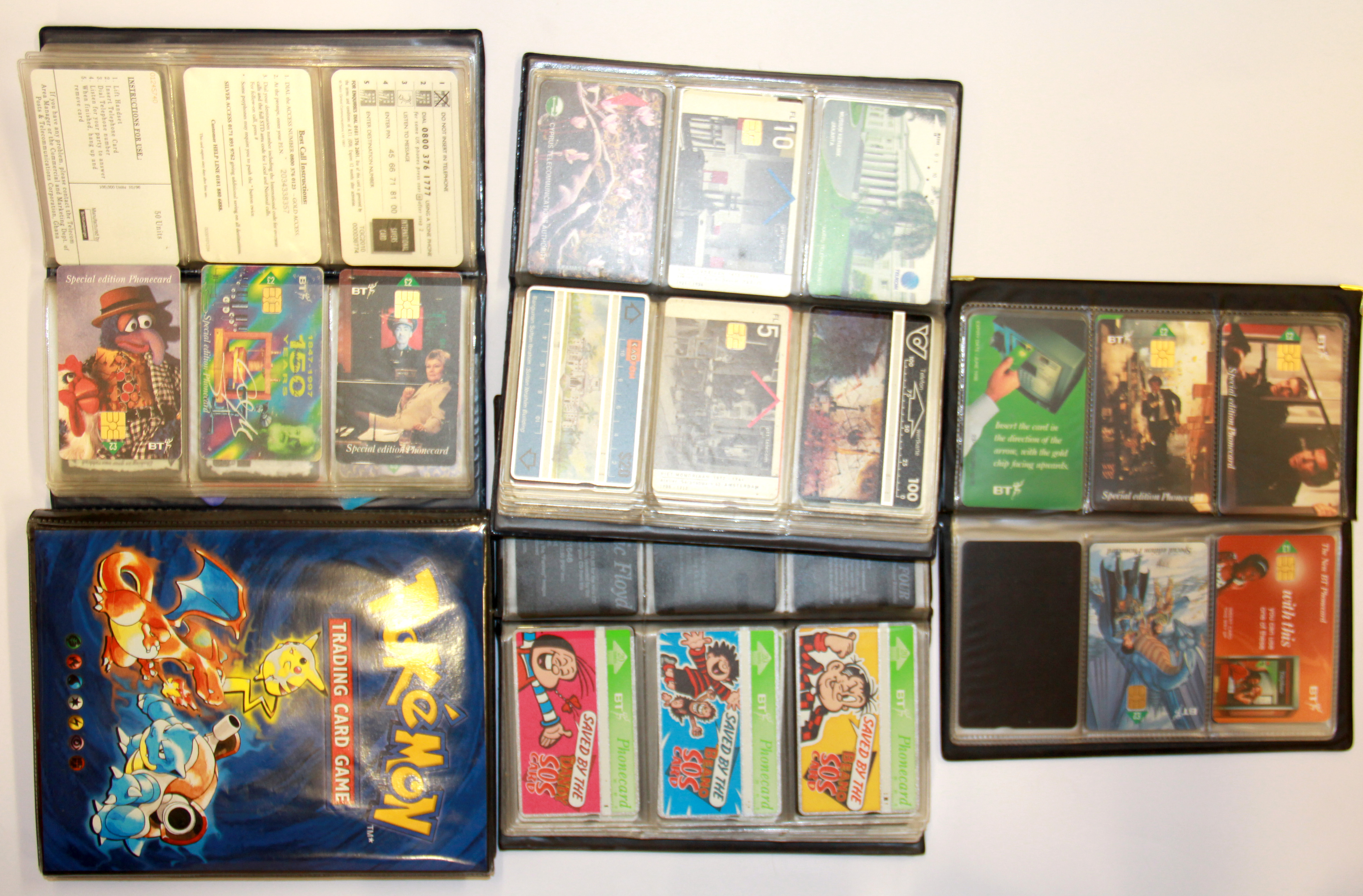 Four albums of collectors phone cards and Pokemon trading cards.