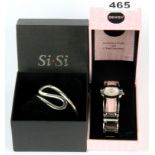 A boxed SiSi bangle with a Seksy wrist watch.